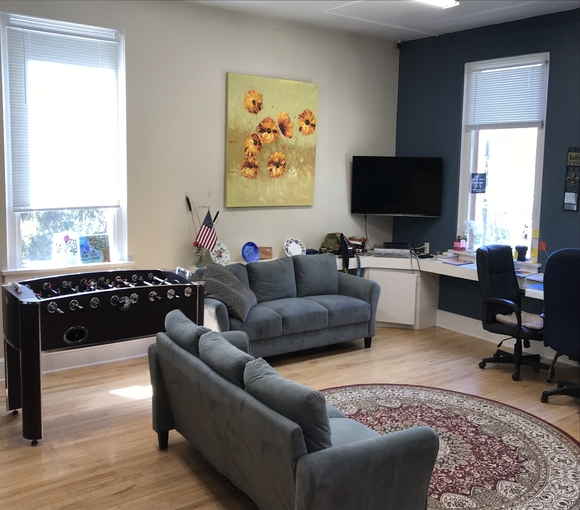 Lounge with sofas, foosball table, and TV