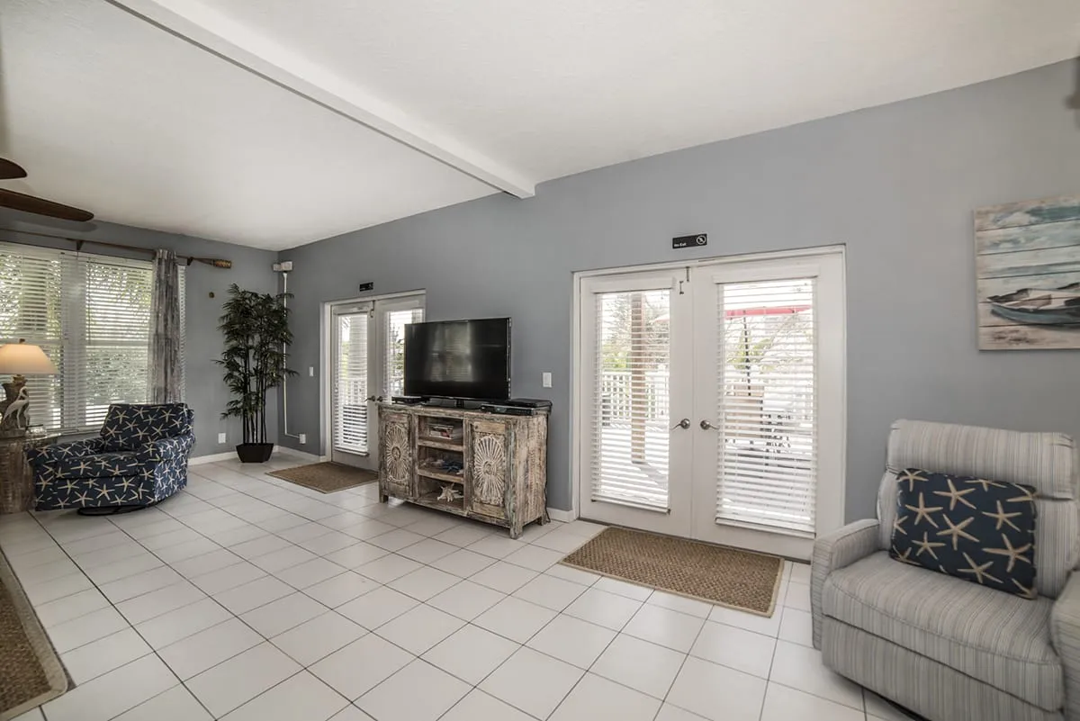 Lounge space with TV, recliners, and double patio doors