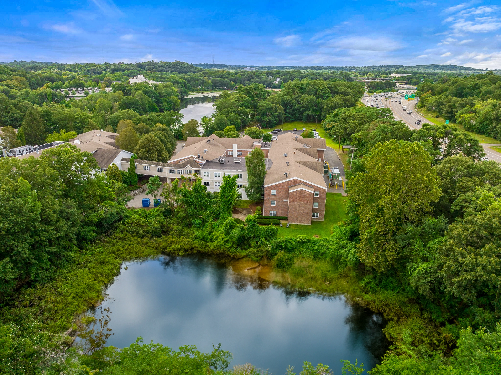 Aerial view of facility showing pond and greenery.
