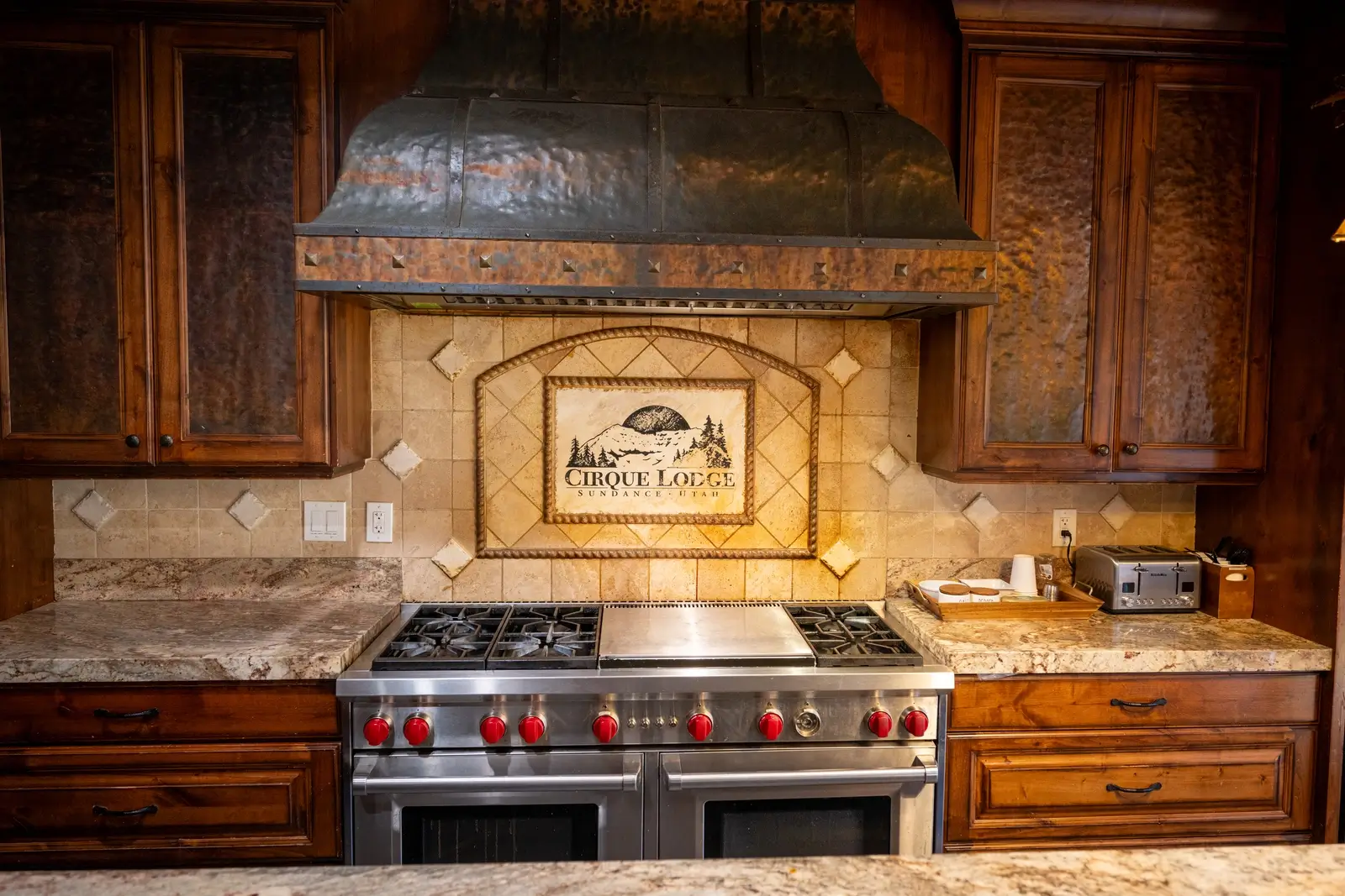 Gourmet kitchen with double oven and lodge-style tilework