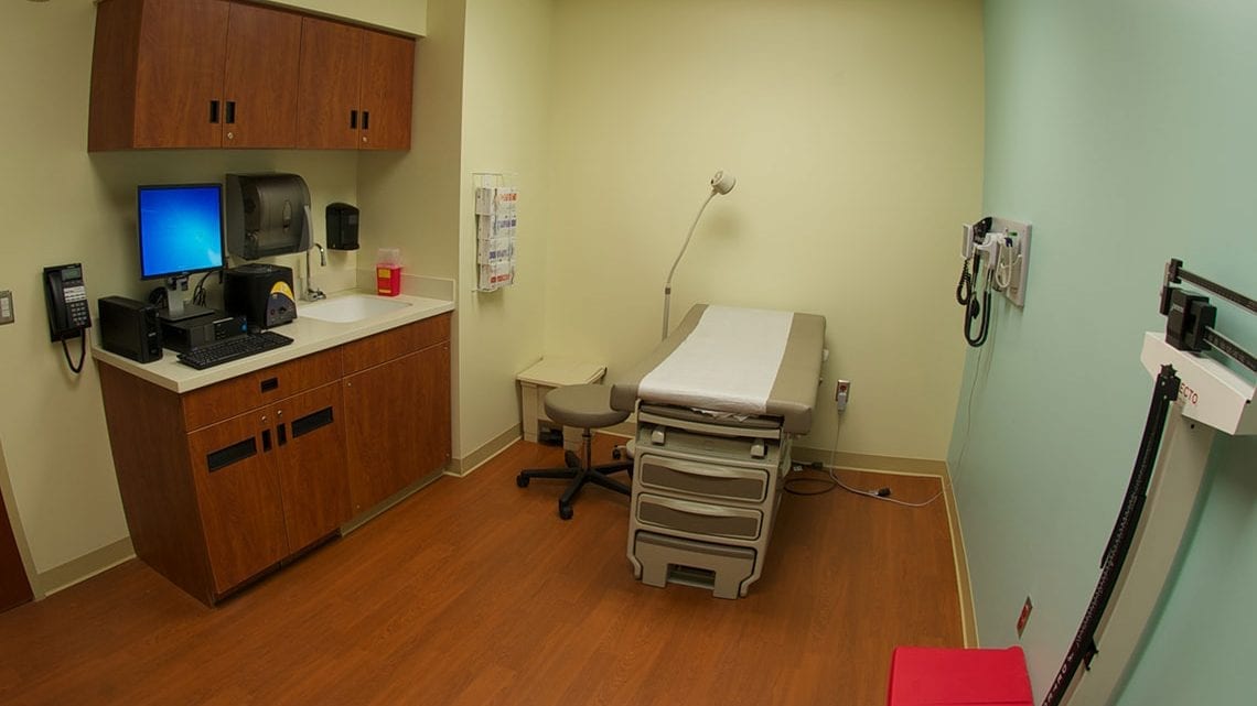 Medical exam room with exam table and equipment