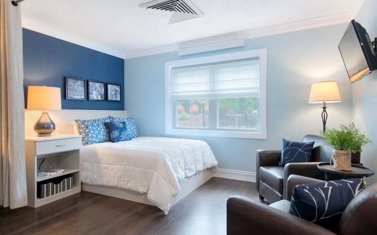 Private bedroom with a seating area and side-table.