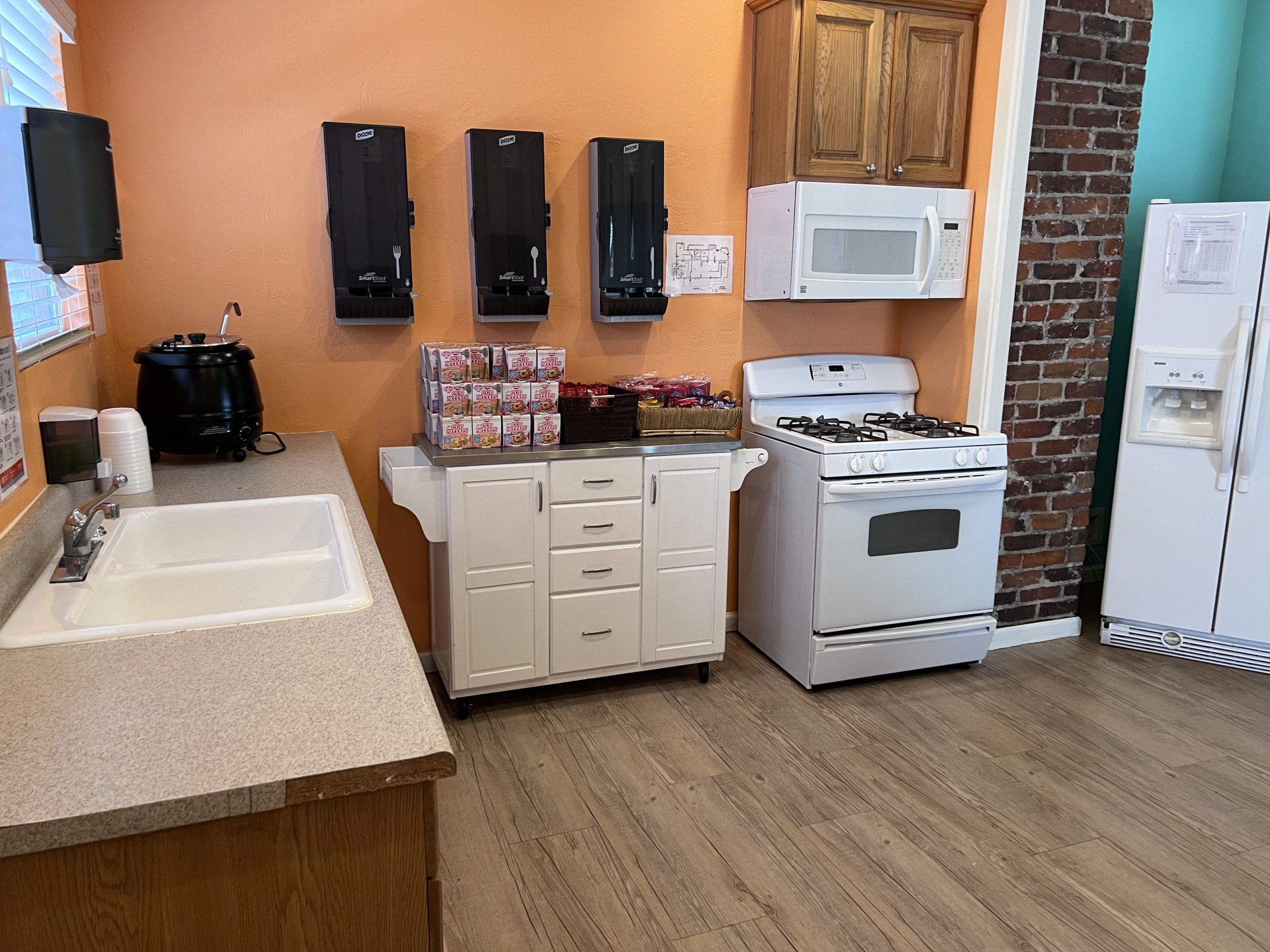 Stove, fridge, and ramen cups in shared kitchen