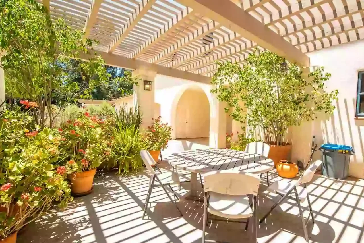 Shaded outdoor patio with seating and garden plants