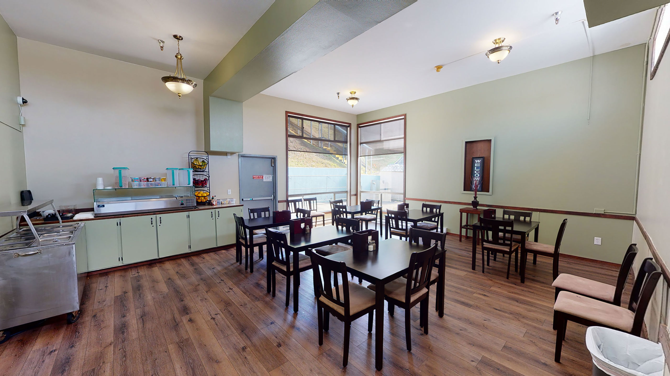 Dining area with food counter and black tables