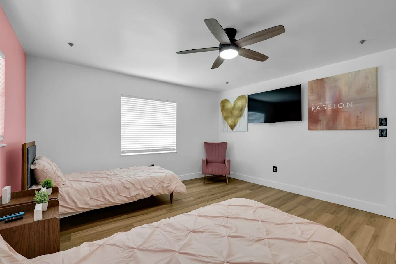 Furnished shared bedroom with television and seating
