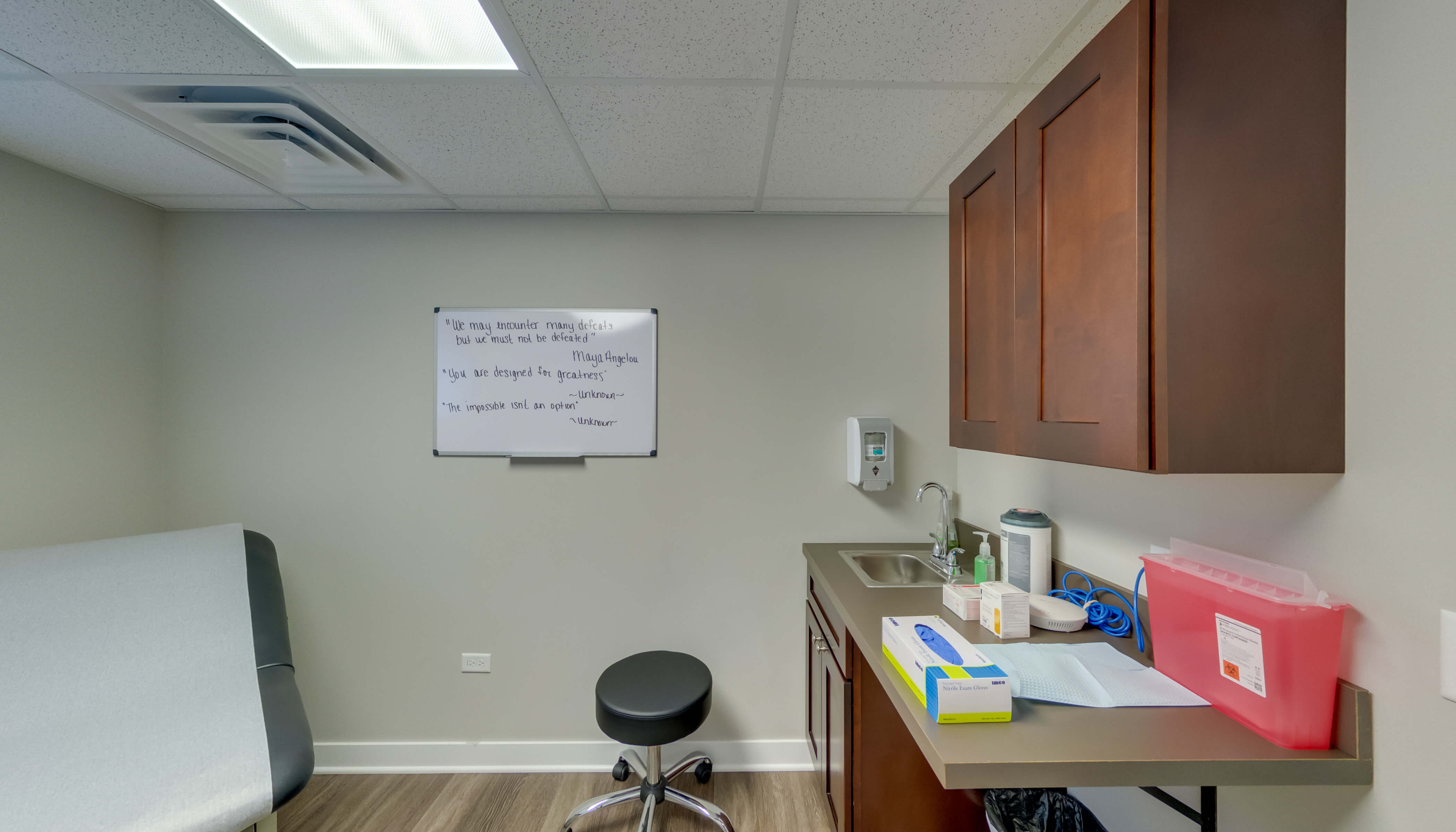 Examination room with a chair, and whiteboard in background.