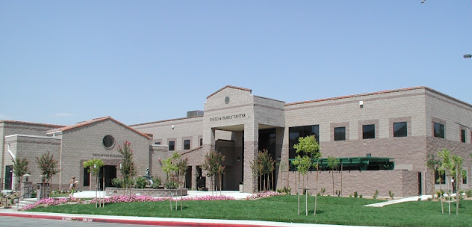  Front view of the Child & Family Center in Santa Clarita, showcasing a welcoming entrance and vibrant greenery.