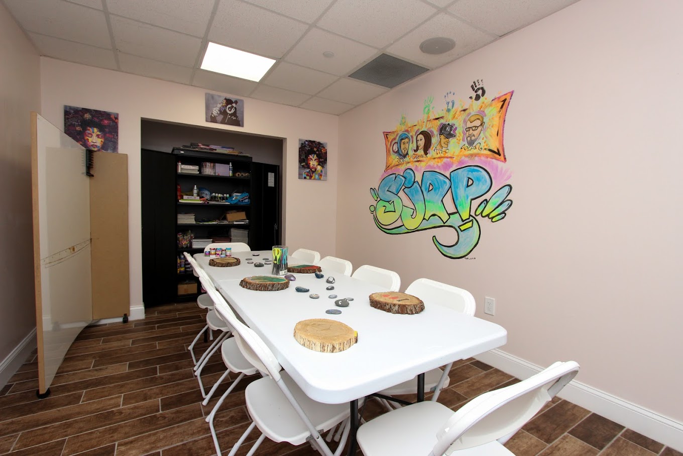Art therapy room with colorful mural and supplies.