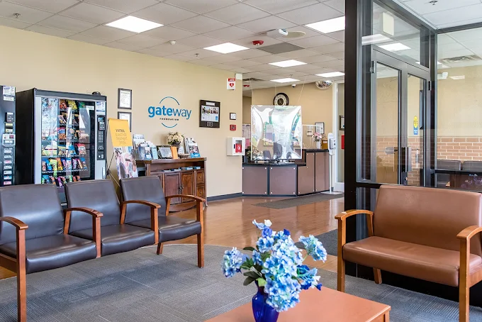 Lobby with seating area, front desk, and vending machines