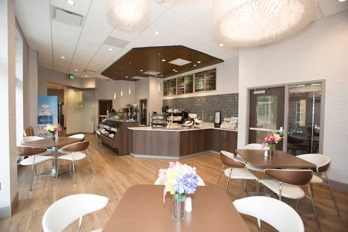 Dining area with tables and cafe-style food counter