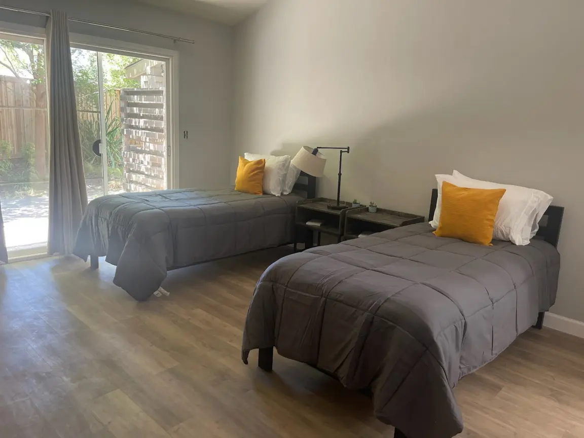 Two twin beds with outdoor view and nightstands