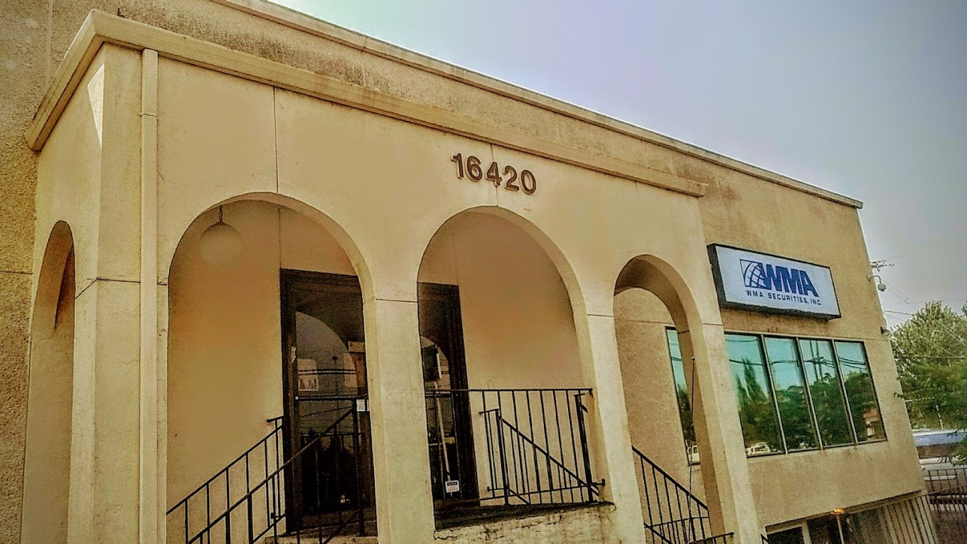 Beige building with arched entryway and signage