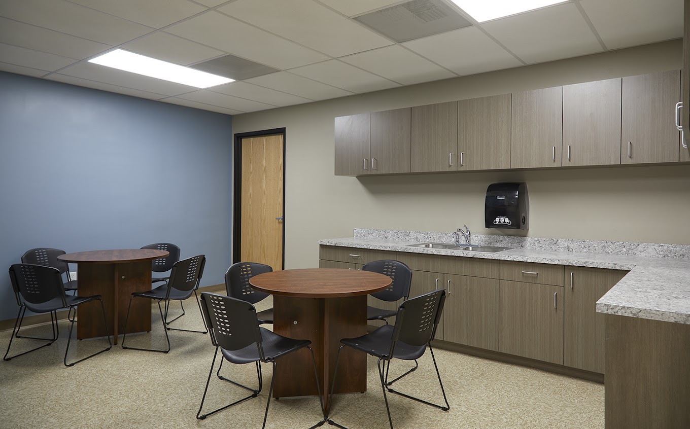 Break room with  tables and seating.