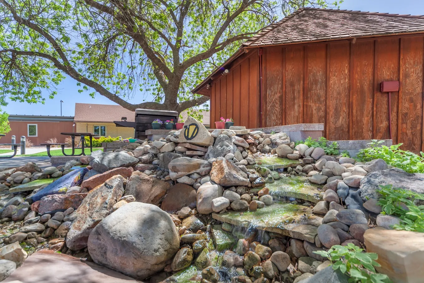Open courtyard lawn with benches and treatment buildings