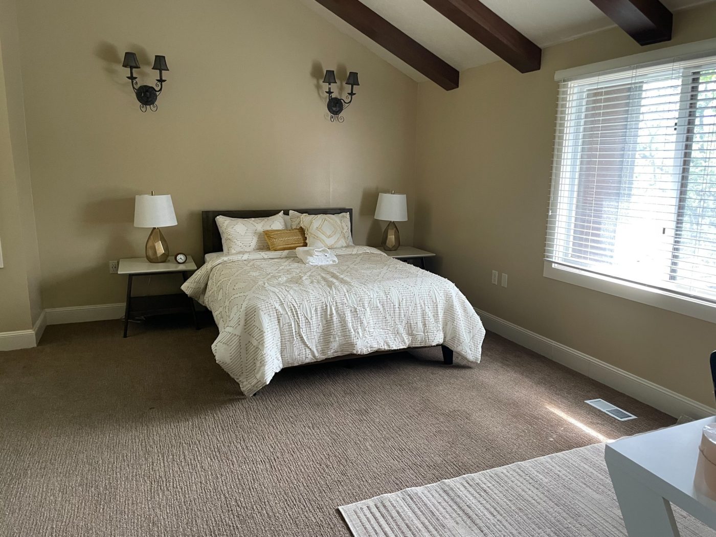 Bedroom with queen bed and large window