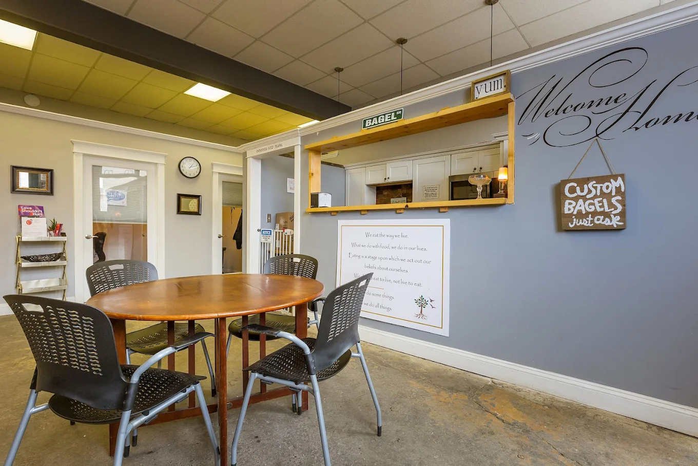 Dining area with round table, bagel counter, and wall décor