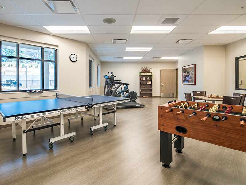 Recreation room with ping-pong, foosball, and exercise bikes