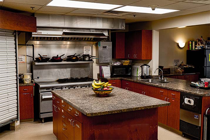 Rehab kitchen with stainless range and prep island