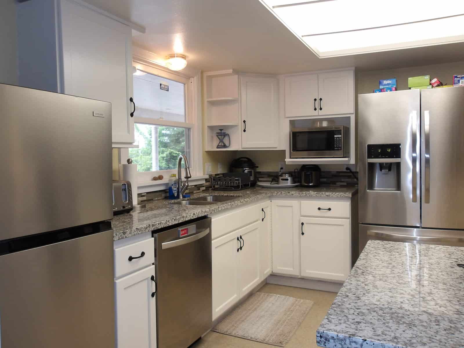 Fully equipped kitchen with modern appliances and cabinets