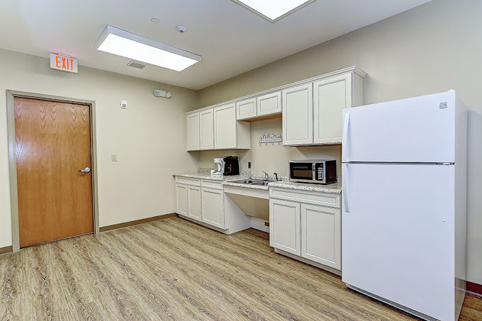 Small kitchenette with fridge, microwave, and coffee maker.
