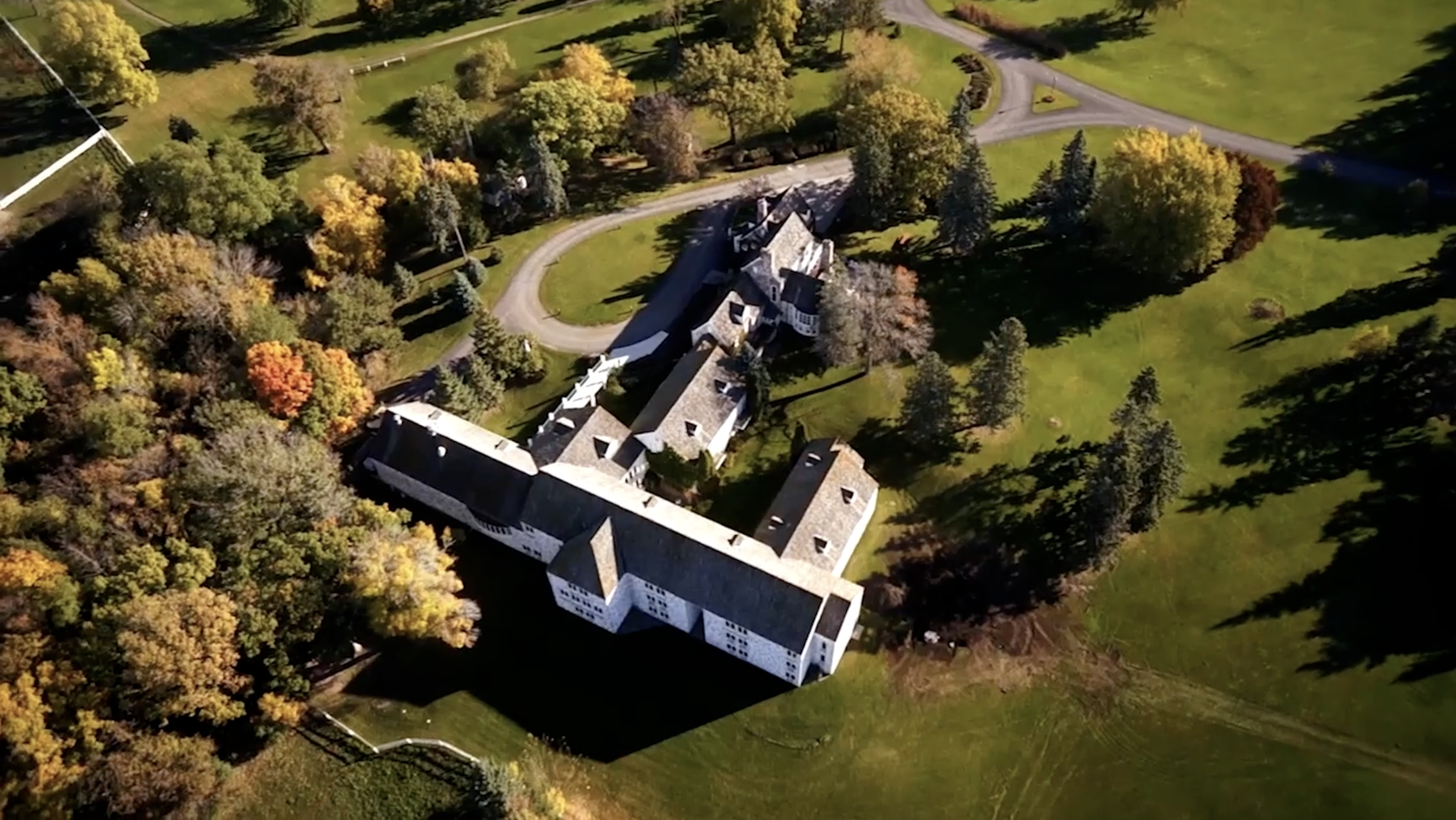 Aerial view of campus buildings surrounded by open green space.