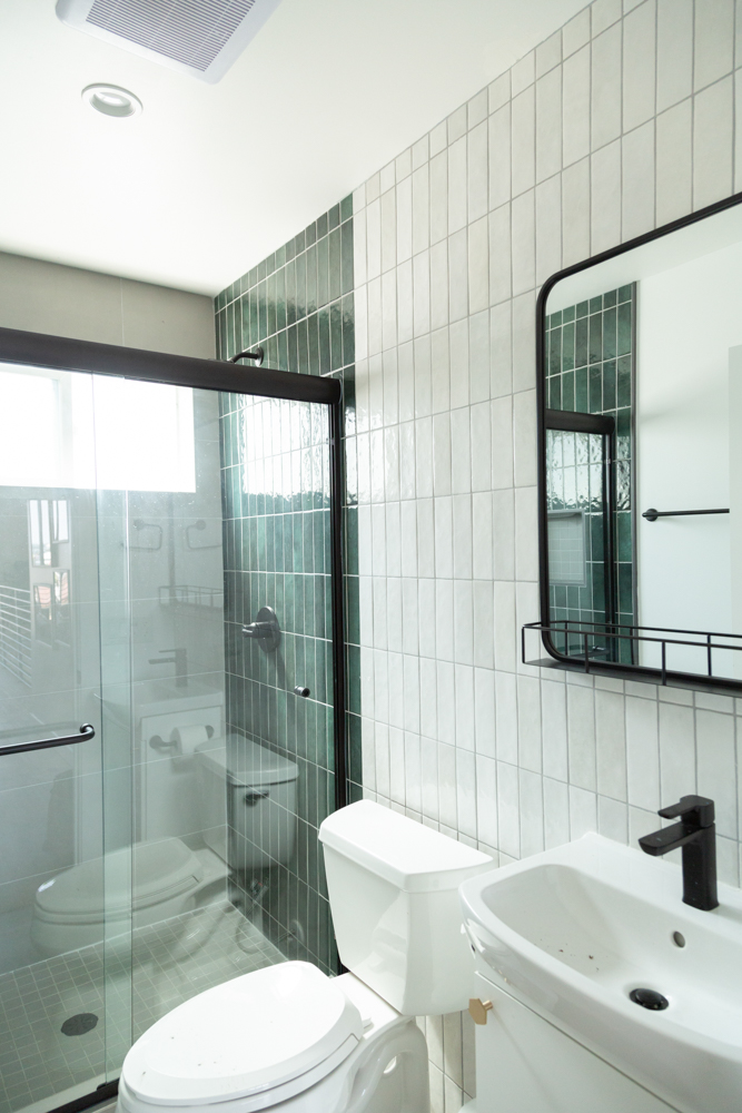 Sleek bathroom with glass shower and tiled walls