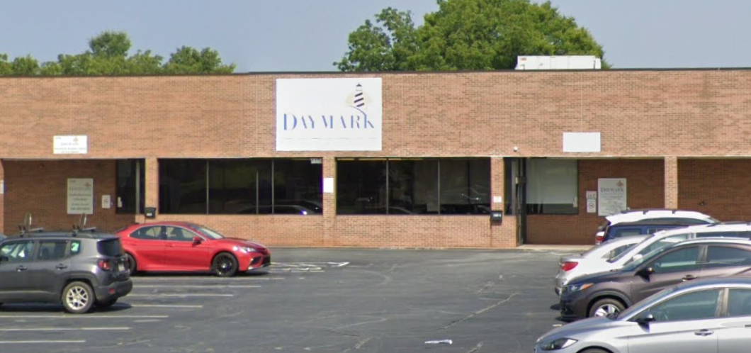 Brick building exterior with parking lot and entrance
