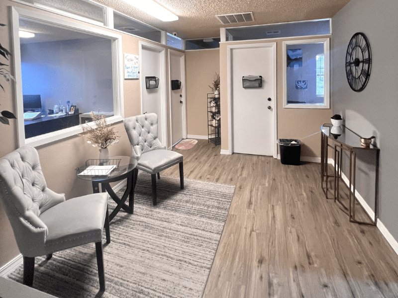 Two tufted chairs and a rug in a calm waiting room