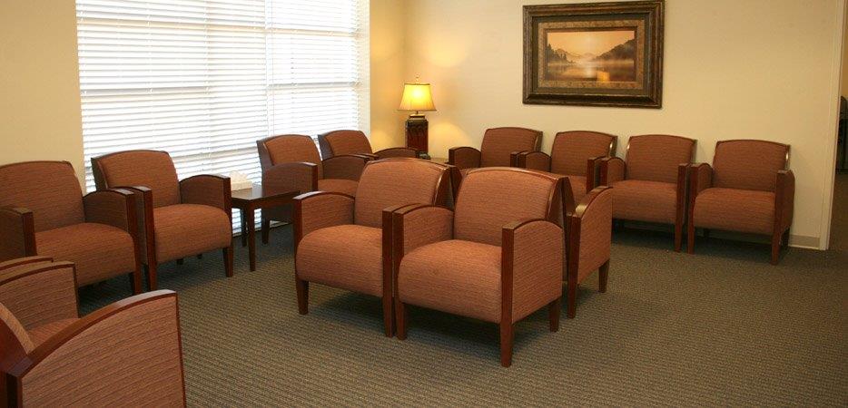 Waiting room with orange armchairs and soft lighting