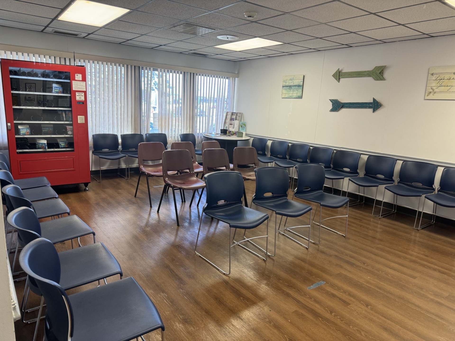Spacious waiting room with seating and vending machine