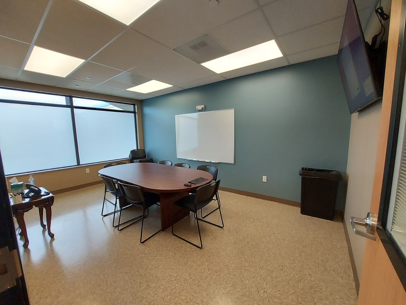 Group therapy room with chairs in a circle around a table.