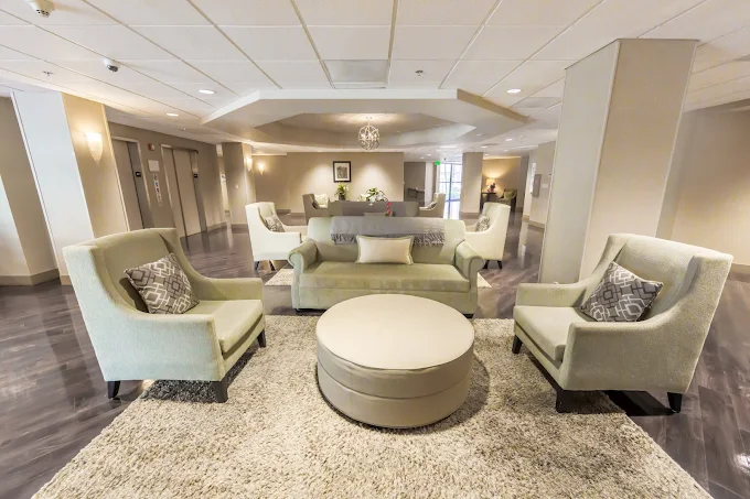 Lounge with sofas, armchairs, and a round ottoman seating area