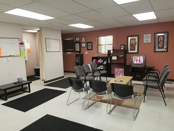 Waiting area with chairs and a TV.