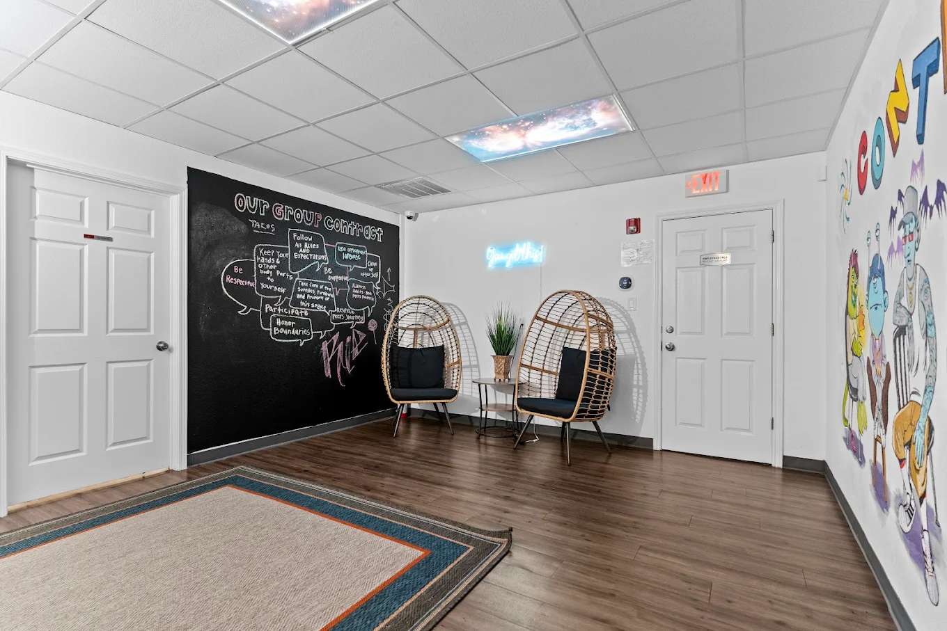 Group room with chairs, chalkboard wall, and lounge seating