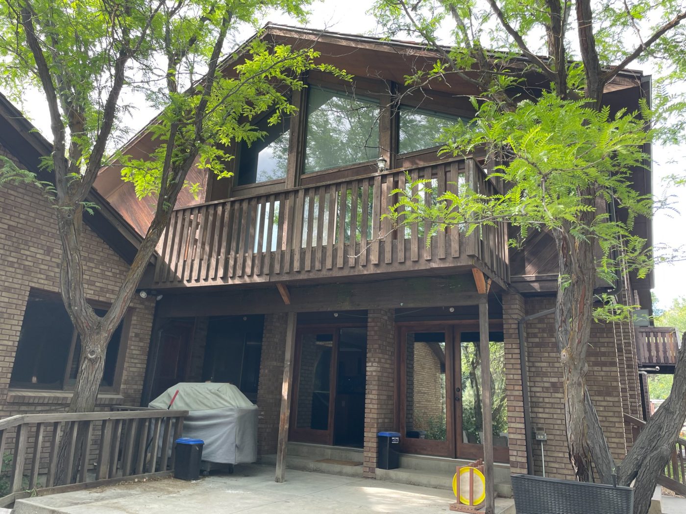 Brick and wood exterior with second-story balcony