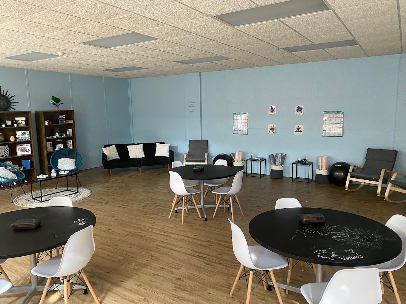 Group therapy room with round tables, chairs and blue walls.