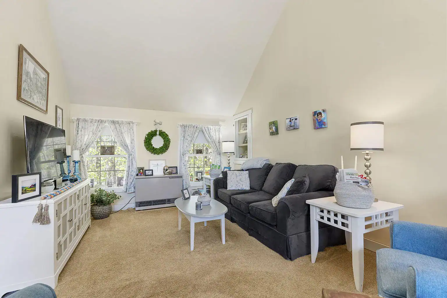 Comfortable living room with seating, natural light, and home-like furnishings at Southern Maine Recovery