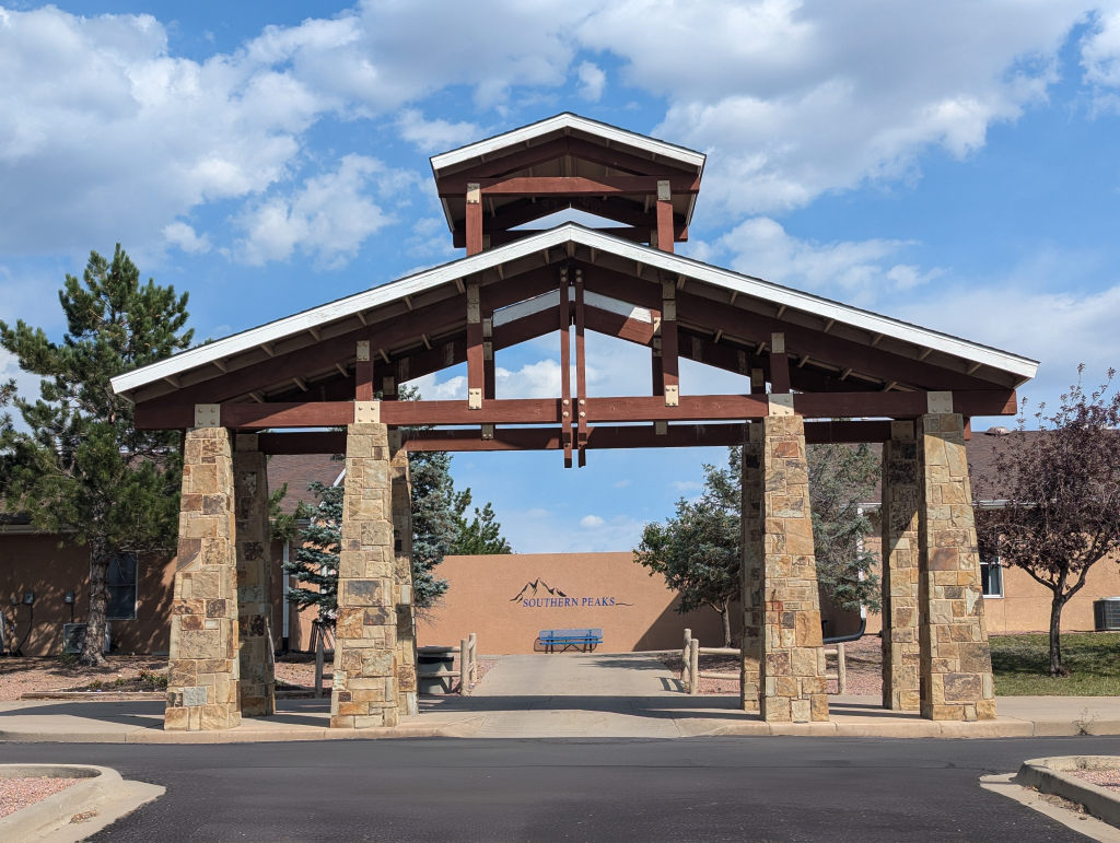 Stone and timber entrance pavilion at Southern Peaks RTC in Canon City