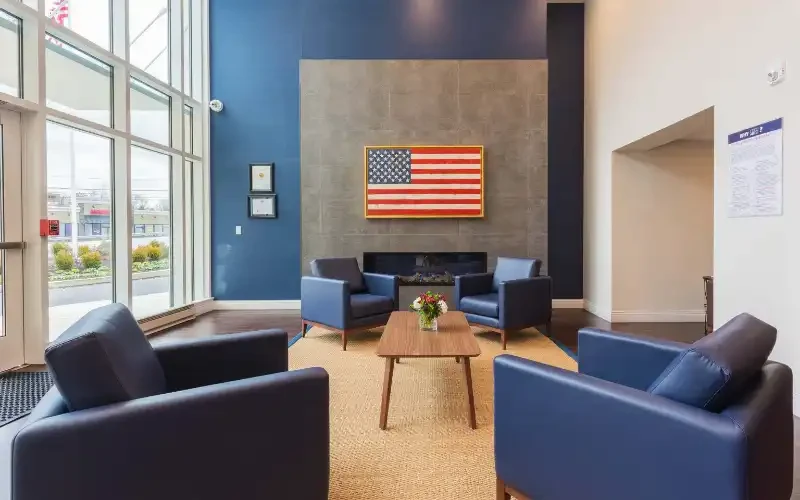 Lounge with blue chairs and American flag wall
