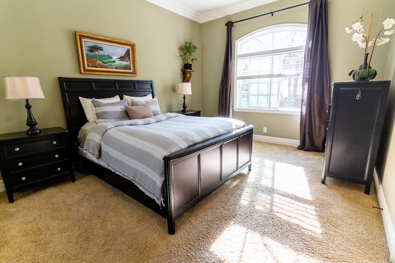 Queen bed with two nightstands and natural light