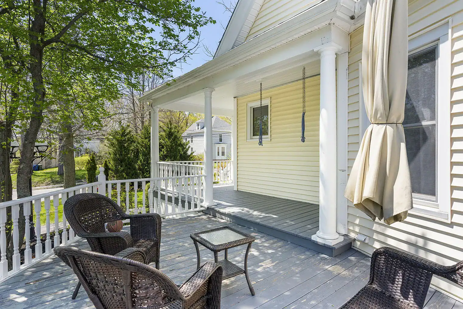 Covered front porch with outdoor seating at Southern Maine Recovery residential treatment center