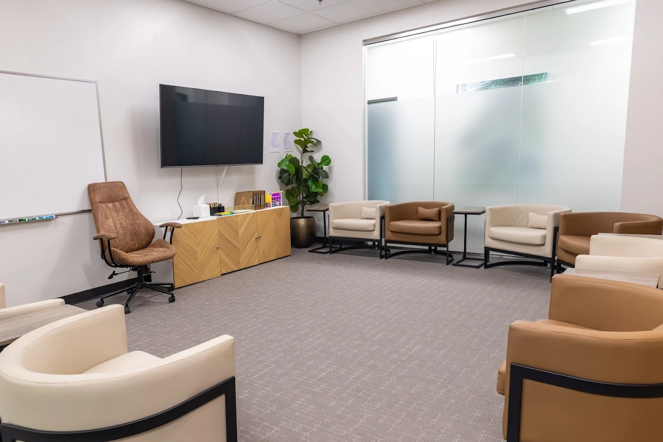Therapy room with armchairs and whiteboard