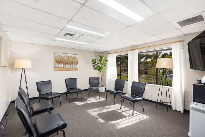 Group therapy room with chairs in a bright meeting space