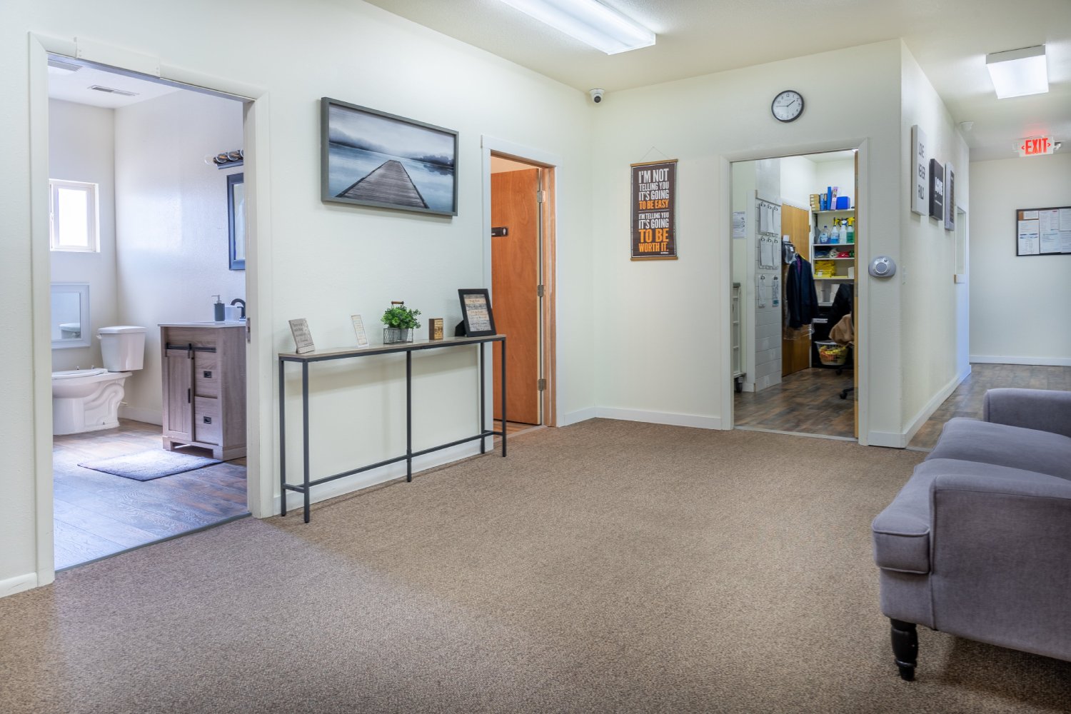 Hallway with a small table, chairs, and decor
