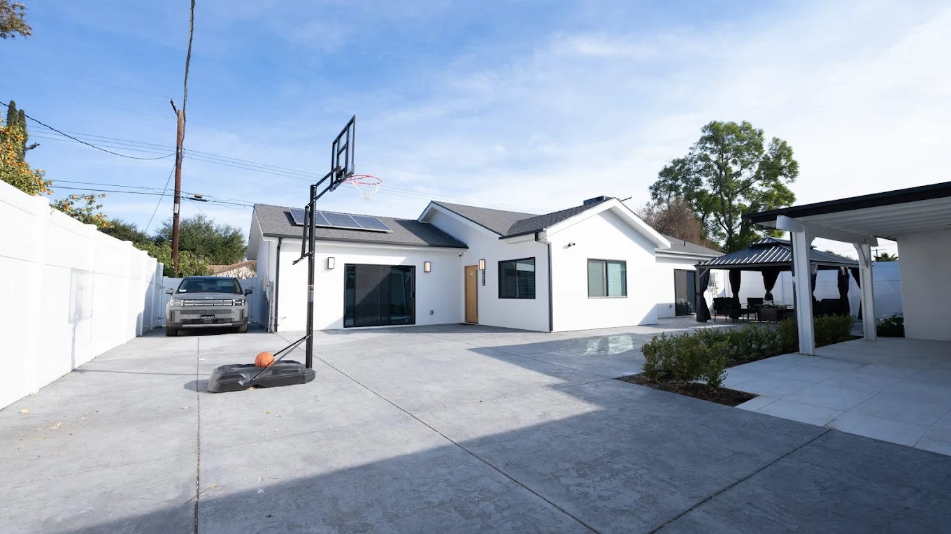 Backyard patio with basketball hoop and seating area