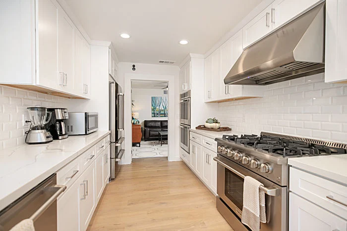 Bright kitchen with gas range and modern appliances