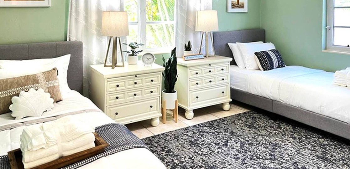 Shared bedroom with two beds and bedside tables