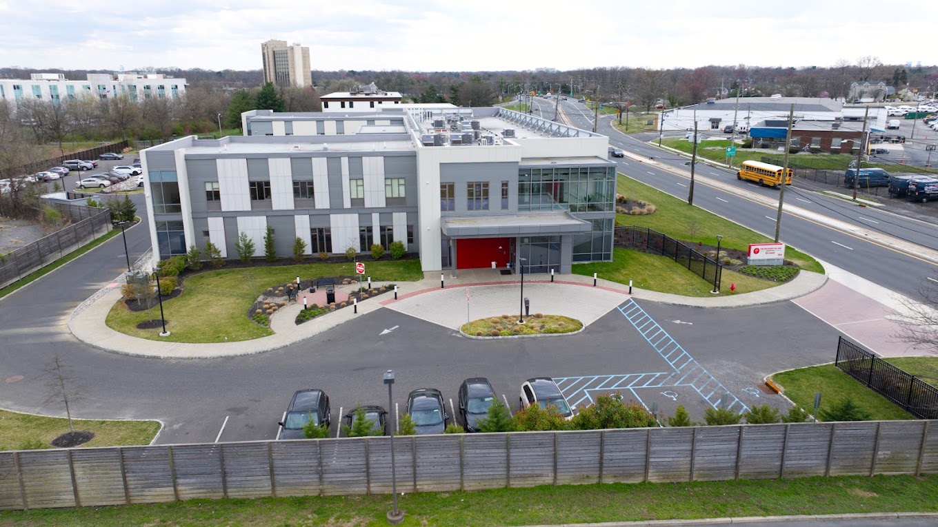 Aerial veiw of facility featuring modern design and signage.