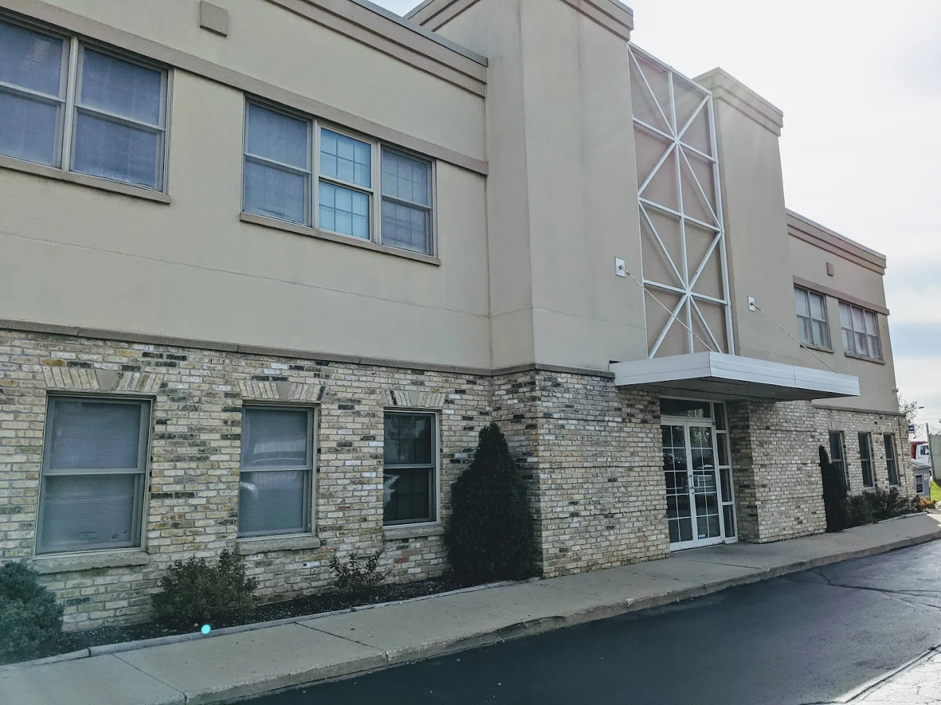 Two-story clinic with brick and tan siding